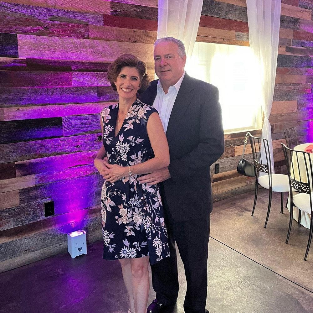 Veronique and Dan at an event with purple lighting
