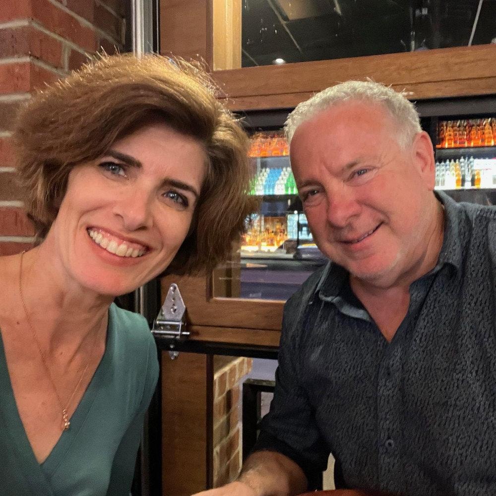 Veronique and Dan smiling at dinner
